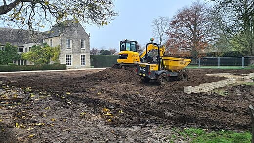 Laying topsoil before trenching for irrigation system