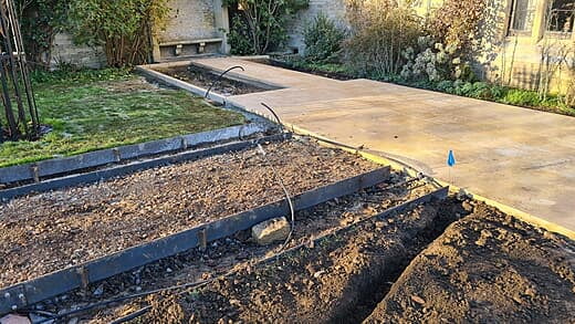 Trench approaching at the corner of the main lawn where a popup sprinkler gets