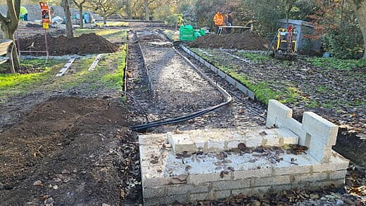 Irrigation pipes sticking out on left side before trenching to cross the path