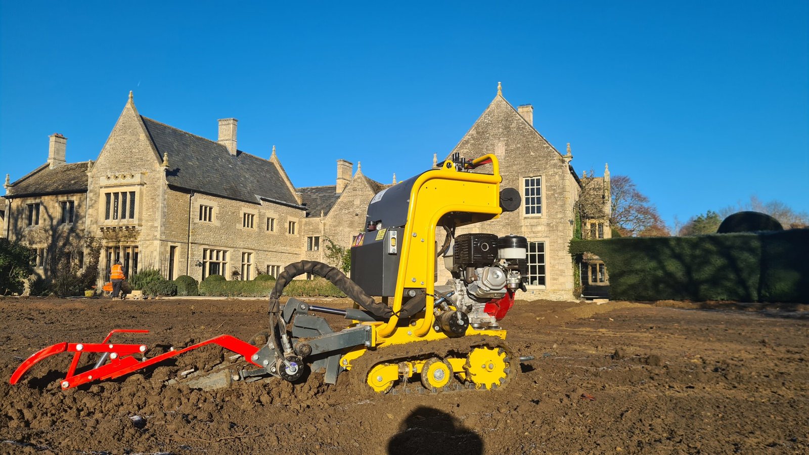 Our self-propelled lightweight trenching machine in front of the main building in Polebrook