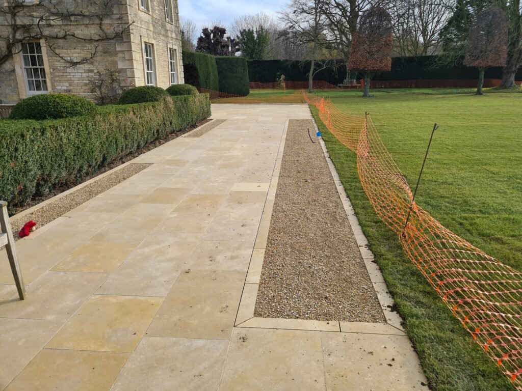 Large stone planters are designed over the shingle lane.